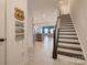 Inviting entryway with staircase, decorative license plates and view into the living spaces at 11120 Pagebrook Ln, Charlotte, NC 28214