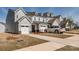 View of newly constructed townhomes with attached garages and well-manicured lawns on a sunny day at 11120 Pagebrook Ln, Charlotte, NC 28214