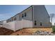 View of the house exterior featuring a new privacy fence at 11120 Pagebrook Ln, Charlotte, NC 28214