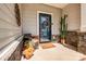 Charming front porch with a decorative door, potted plants, and a welcome mat at 11120 Pagebrook Ln, Charlotte, NC 28214