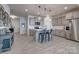Spacious kitchen with an island, stainless steel appliances, and stylish gray cabinetry at 11120 Pagebrook Ln, Charlotte, NC 28214