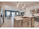 Modern kitchen featuring stainless steel appliances, quartz countertops, and open layout to the living area at 11120 Pagebrook Ln, Charlotte, NC 28214