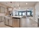 Modern kitchen with stainless steel appliances, an island with a sink, and an open view to the living room at 11120 Pagebrook Ln, Charlotte, NC 28214
