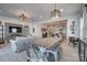 Open-concept living room and dining area with a decorative wall and modern light fixtures at 11120 Pagebrook Ln, Charlotte, NC 28214