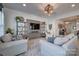 Cozy living room features comfortable seating, a large TV, and elegant décor with shelving units at 11120 Pagebrook Ln, Charlotte, NC 28214