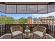 Relax on this cozy balcony featuring neutral toned chairs and a lovely view at 1300 Queens Rd # 408, Charlotte, NC 28207