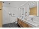 A bright bathroom featuring a double sink vanity, walk-in shower, and modern fixtures at 1300 Queens Rd # 408, Charlotte, NC 28207