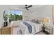 Inviting bedroom with large windows showcasing trees, a ceiling fan, and hardwood floors at 1300 Queens Rd # 408, Charlotte, NC 28207