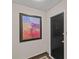 Hallway featuring a black door marked '408' beside a colorful square painting in a black frame at 1300 Queens Rd # 408, Charlotte, NC 28207