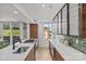 Open kitchen design with stainless steel appliances, island with seating, and hardwood floors at 1300 Queens Rd # 408, Charlotte, NC 28207