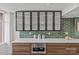 Contemporary kitchen featuring glass-front cabinets, modern appliances, and tiled backsplash at 1300 Queens Rd # 408, Charlotte, NC 28207