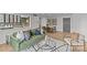 A stylish condo living room with green sofa, round glass coffee table, and kitchen with subway tile backsplash at 1300 Queens Rd # 408, Charlotte, NC 28207