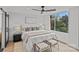A bright main bedroom with a large window and ceiling fan at 1300 Queens Rd # 408, Charlotte, NC 28207