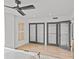A bright bedroom featuring a ceiling fan, closet with opaque sliding doors, and hard wood flooring at 1300 Queens Rd # 408, Charlotte, NC 28207