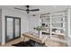 Bright office features a large window, modern ceiling fan, a cowhide rug, and built in shelving at 1300 Queens Rd # 408, Charlotte, NC 28207