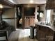 This is a living room and kitchen space with modern wood paneling and an entertainment center at 137 Landlubber Trl, Mount Gilead, NC 27306