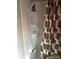 Clean shower with built-in shelving and a showerhead with a decorative gray shower curtain at 137 Landlubber Trl, Mount Gilead, NC 27306