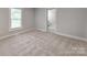 Cozy carpeted bedroom with a window and view to adjacent bathroom at 1401 Birch St, Kannapolis, NC 28081
