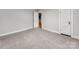 Neutral bedroom with wall-to-wall carpet, white trim, and view to kitchen at 1401 Birch St, Kannapolis, NC 28081