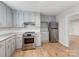 Modern kitchen featuring stainless steel appliances, light gray cabinets, and speckled countertops at 1401 Birch St, Kannapolis, NC 28081