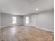 Spacious living room featuring wood floors, neutral paint, and a large window with natural light at 1401 Birch St, Kannapolis, NC 28081