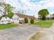 Back of the home, featuring a small outbuilding and a paved driveway and parking area at 1401 Birch St, Kannapolis, NC 28081