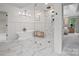 Bright bathroom features marble tile, free-standing tub, and large glass enclosed shower at 1511 Churchill Downs Dr, Waxhaw, NC 28173