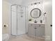 Bathroom featuring a shower with glass doors, vanity with drawers, modern sink and round mirror at 1511 Churchill Downs Dr, Waxhaw, NC 28173
