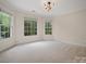 Bright bedroom featuring three large windows that provide lots of natural light at 1511 Churchill Downs Dr, Waxhaw, NC 28173