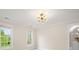 Bright bedroom featuring two windows and a bathroom at 1511 Churchill Downs Dr, Waxhaw, NC 28173