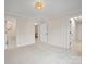 A neutral-toned bedroom with multiple doorways, offering flexibility and space at 1511 Churchill Downs Dr, Waxhaw, NC 28173