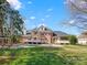 Large brick home with a backyard pool, lounge chairs, and a covered patio at 1511 Churchill Downs Dr, Waxhaw, NC 28173