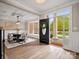 Inviting foyer with hardwood floors, a dining area and large windows allowing natural light to stream inside at 1511 Churchill Downs Dr, Waxhaw, NC 28173