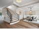 Grand foyer with hardwood floors, elegant staircase, open dining area with modern chandelier at 1511 Churchill Downs Dr, Waxhaw, NC 28173