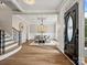 Elegant foyer with hardwood floors, staircase, dining area, and stylish chandelier at 1511 Churchill Downs Dr, Waxhaw, NC 28173