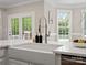Bright kitchen features farmhouse sink with stainless appliances, quartz countertops, and a view of the backyard at 1511 Churchill Downs Dr, Waxhaw, NC 28173