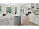 Spacious kitchen features stainless appliances, quartz countertops, and view to the breakfast area and living room at 1511 Churchill Downs Dr, Waxhaw, NC 28173