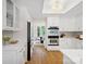 Bright kitchen features stainless steel appliances, white cabinets and quartz countertops, and breakfast area at 1511 Churchill Downs Dr, Waxhaw, NC 28173