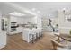 Bright, eat-in kitchen features a large island with seating, white cabinetry, and stainless steel appliances at 1511 Churchill Downs Dr, Waxhaw, NC 28173
