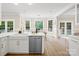 Open concept kitchen features stainless appliances, quartz countertops, and a view of the adjacent dining area at 1511 Churchill Downs Dr, Waxhaw, NC 28173