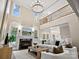 Spacious living room with fireplace, two-story ceilings, iron railing, and abundant natural light at 1511 Churchill Downs Dr, Waxhaw, NC 28173