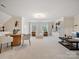 Spacious living room featuring modern furniture, built-in shelving, and large windows at 1511 Churchill Downs Dr, Waxhaw, NC 28173