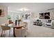 Open-concept living room showcasing a dining area and comfortable seating with natural light at 1511 Churchill Downs Dr, Waxhaw, NC 28173
