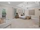 Inviting main bedroom features a decorative tray ceiling, abundant natural light, and calming, neutral decor at 1511 Churchill Downs Dr, Waxhaw, NC 28173