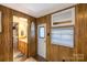 Interior view of a bathroom with wood-look walls and a mirror at 167 Holly Harbor Trl # 169/170, Mount Gilead, NC 27306