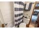 Bathroom with a shower featuring a striped curtain, a toilet, and coordinated towel set, enhancing the space at 167 Holly Harbor Trl # 169/170, Mount Gilead, NC 27306
