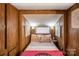 Inviting bedroom with wood-look walls and natural light at 167 Holly Harbor Trl # 169/170, Mount Gilead, NC 27306