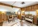 Cozy dining room features wood-paneled walls, a table and chairs, and is decorated with floral arrangements at 167 Holly Harbor Trl # 169/170, Mount Gilead, NC 27306