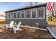 Attractive sunroom exterior with Adirondack chairs and well-maintained landscaping at 167 Holly Harbor Trl # 169/170, Mount Gilead, NC 27306