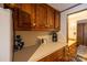Kitchen area with a view into the bathroom, showcasing wooden cabinets and modern appliances at 167 Holly Harbor Trl # 169/170, Mount Gilead, NC 27306